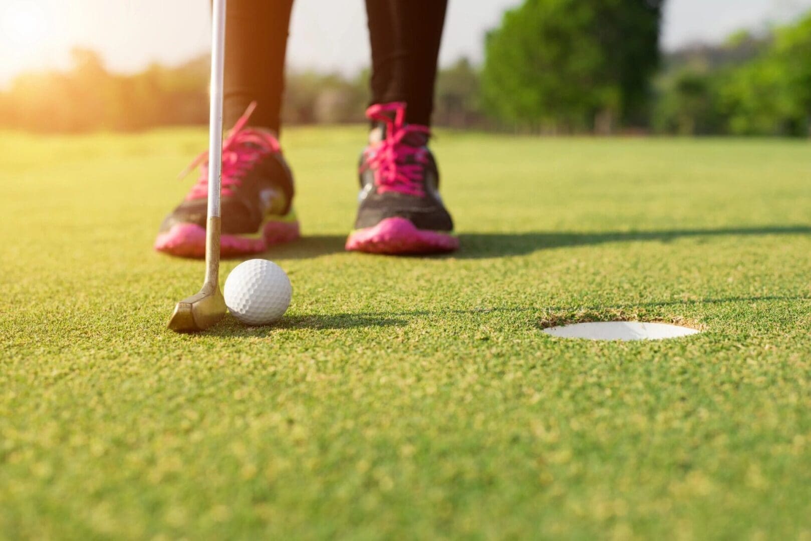 A person is playing golf on the green.